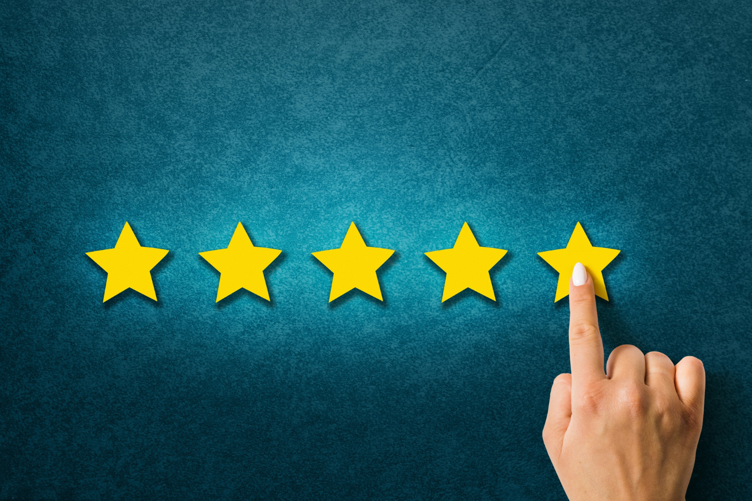 Hand placing the fifth star on a blue background, symbolizing excellent customer rating in a Google review.